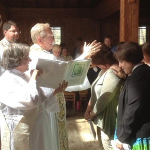 Bishop Hahn lays hands on Mary to confirm her.